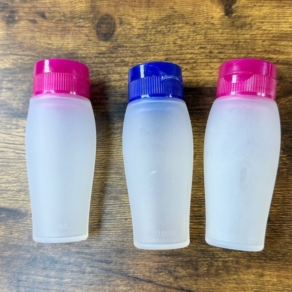 Set of Three Frosted Travel Bottles with Pink and Blue Caps